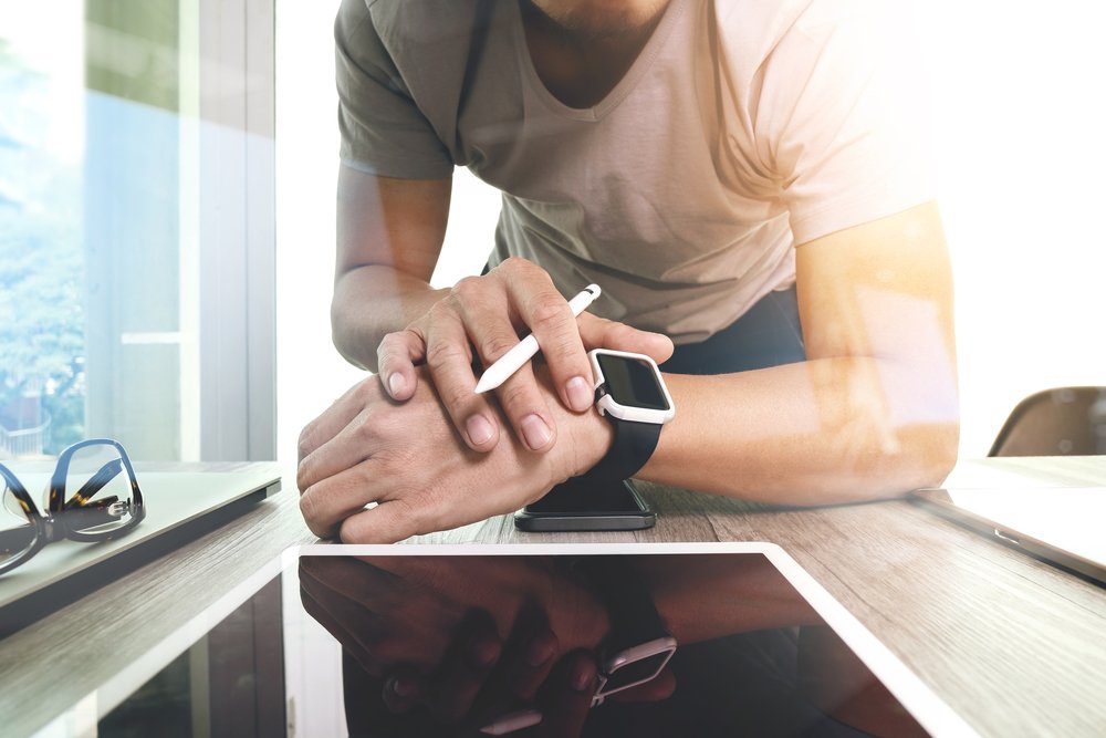 Hold time - contact center problems - man looking at smart watch